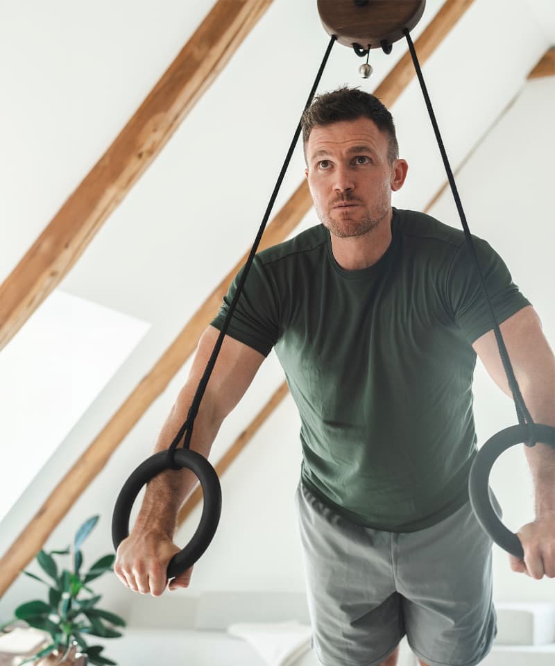Krafttraining an Turnringen aus Holz von rollholz für effektives Bodyweight-Training.